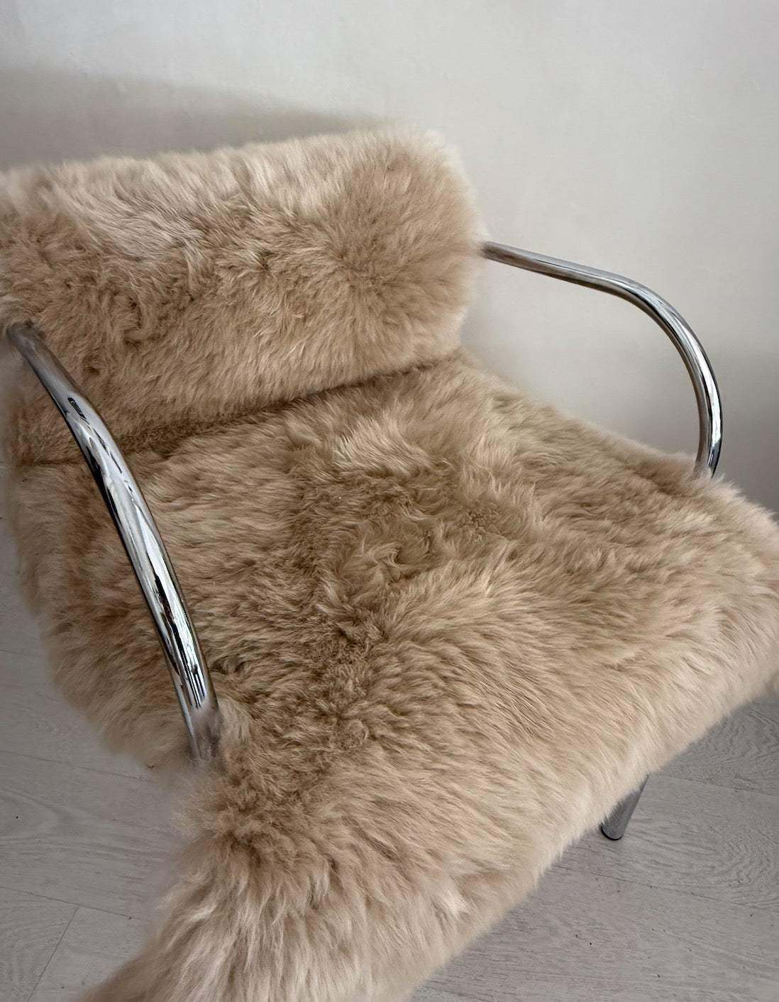 Retro silver armchair with camel wool sheepskin.